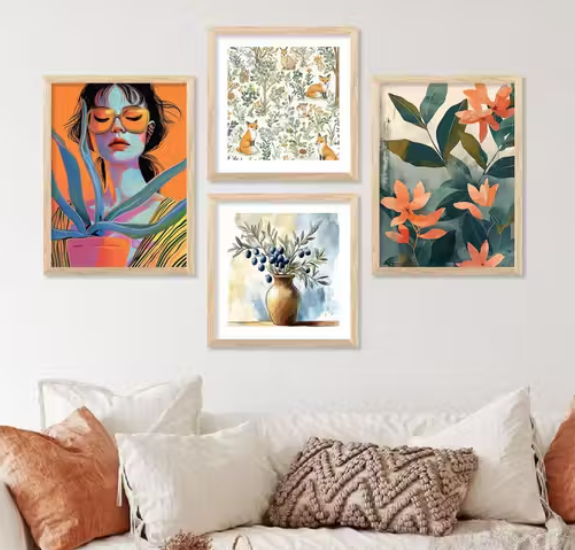 Colorful wall art prints on a white wall above a sofa with pillows.
